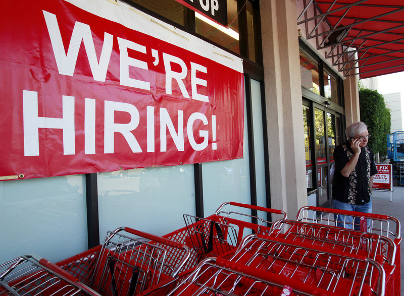 A “We’re Hiring” banner hangs near the entrance of an Office Depot in Mountain View, Calif., on Monday. Hiring overall, however, is sluggish – May’s job openings were 37 percent above the low point set in July, 2009, but are far below pre-recession levels.