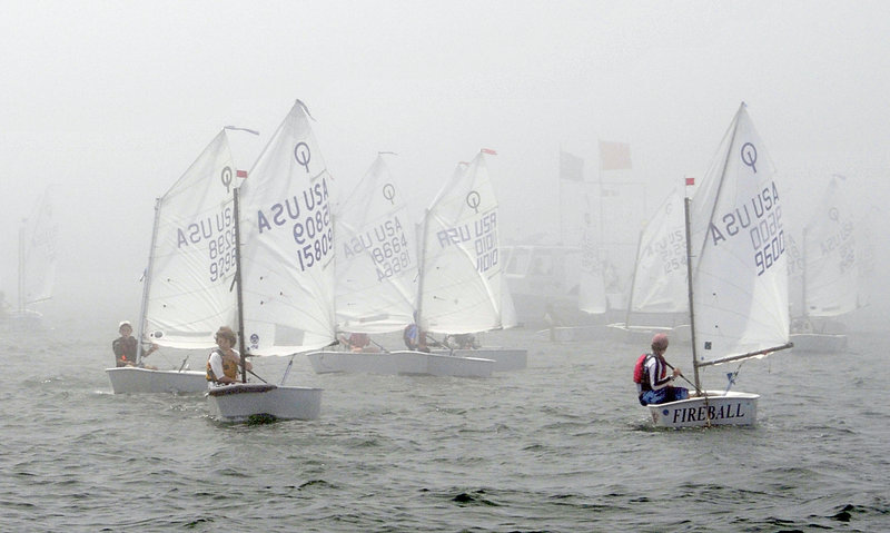 The young sailors in the Optimist class wait for the fog to clear Tuesday while preparing to race in Casco Bay during the opening day of the USA Junior Olympic Sailing Festival Northeast Youth Championships. The fog eventually did burn off.