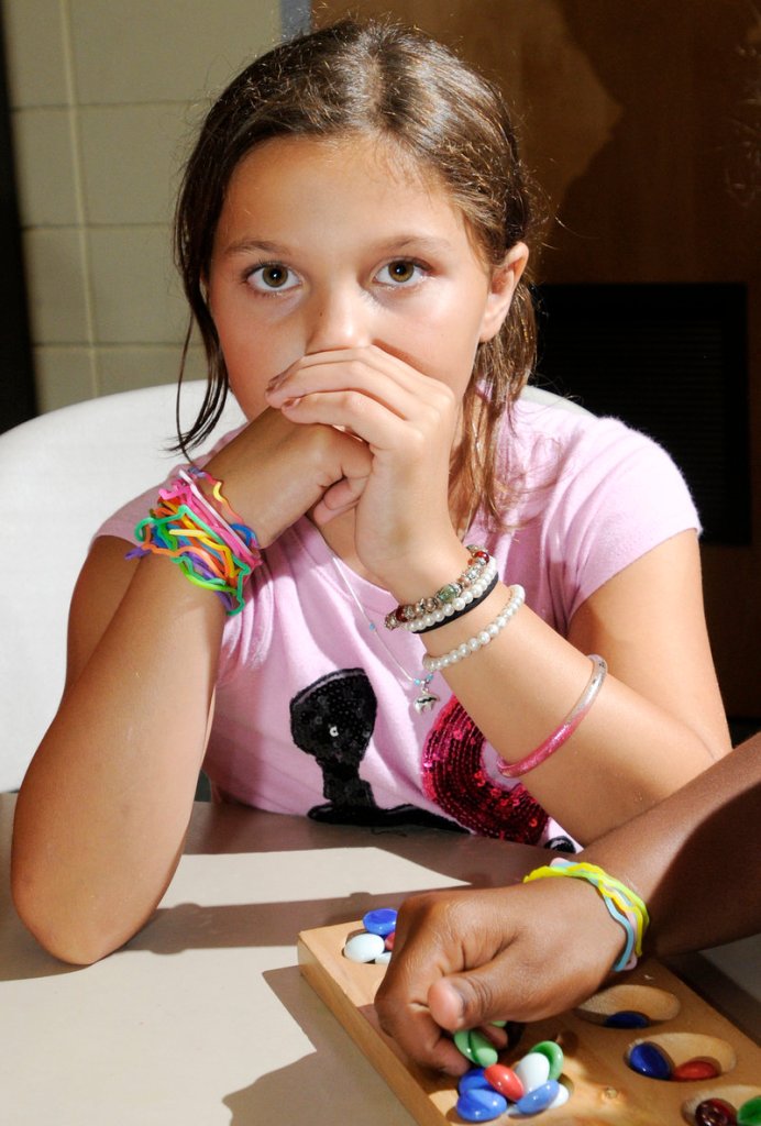 Janelle Sperdakos, 10, waits her turn while playing Mancala. Silly Bandz, essentially rubber bands that retain specific shapes, are the products of BCP Imports of Ohio.