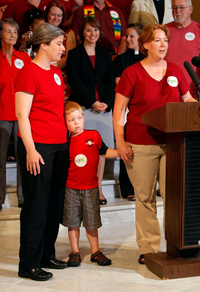 Carla Hopkins, right, accompanied by her son, Eli Hopkins, 5, and her partner, Virginia Eleftheriou, all of Mount Vernon, Maine, speaks in favor of same-sex marriage during a news conference at the State House. Gov. John Baldacci also spoke, telling the crowd that he was “proud to be a part” of the campaign for gay marriage.