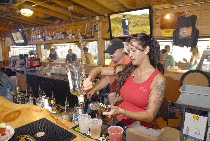 Bartender Melanie Pearson mixes drinks at Bentley's Saloon in Arundel. It's popular with bikers, but its blend of food, drink and entertainment draws all kinds.