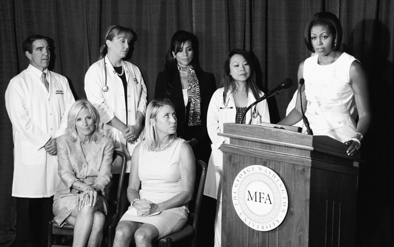 First lady Michelle Obama, right, speaks Wednesday about the Affordable Care Act’s preventive coverage. With her are Jill Biden, the vice president’s wife, seated at left, and hospital staff at George Washington Medical Faculty Associates in Washington.