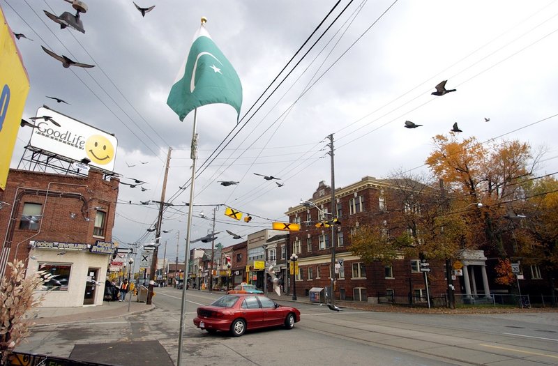 A Pakistani flag flies along a street in Toronto, where many South Asian immigrants have settled. Canada’s immigration policy emphasizes opening the door to skilled professionals and other productive workers.