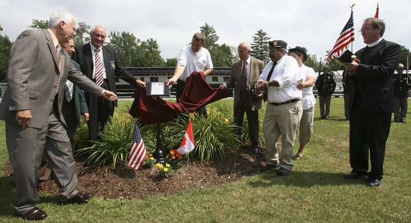 A plaque about the memorial is unveiled at the ceremony.