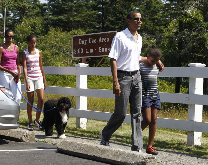 President Obama and his daughter Sasha lead the way as the first family walks toward the Bass Harbor Head Lighthouse on Saturday. They’re followed by Bo, first lady Michelle Obama and older daughter Malia.