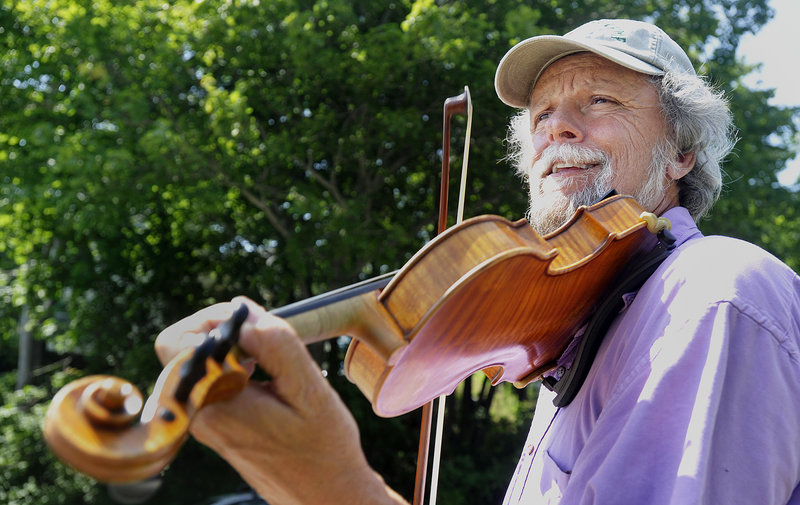 Fiddler Barry Crawford bows a tune at a fiddling workshop on Saturday afternoon. Crawford, who lives in Monroe, is a member of the Belfast Bay Fiddlers band, which will take the stage this morning.