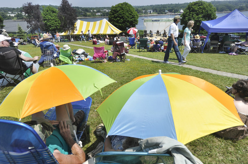 Colorful umbrellas and lawn chairs litter the lawns on Belfast Common Saturday as Celtic music lovers listen to musicians on the music stage at the festival.