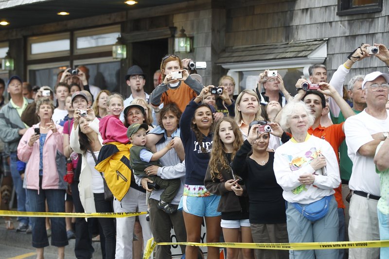 Crowds of camera-clicking onlookers gather to catch a glimpse and a photo of President Obama and his family as they leave a restaurant after dinner in Bar Harbor on Friday evening.
