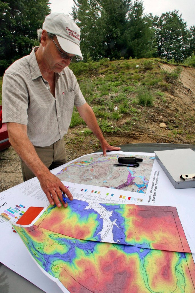 Geologist John Brooks checks maps in New Hampton, N.H. Brooks is helping to map the state’s subsurface.