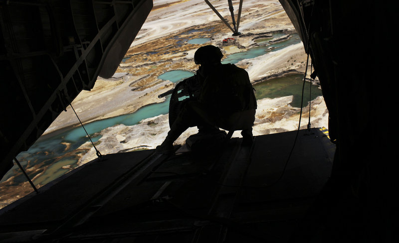 A Marine helicopter door gunner holds a heavy machine gun during a flight over Nimroz province on the border with Helmand province in southern Afghanistan on Saturday.