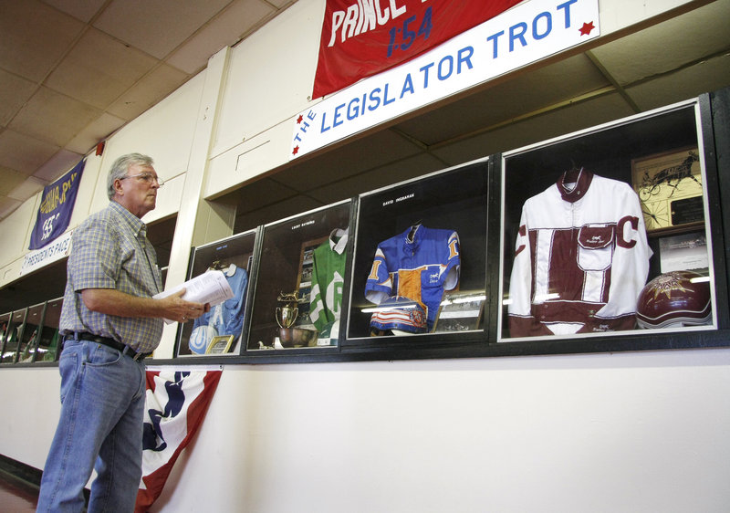 Bill Redden of Rochester, N.H., looks over the Hall of Fame silks that were on display at Scarborough Downs during its celebration.