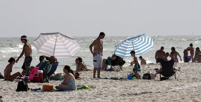 Visitors crowd the beach Saturday in Gulf Shores, Ala., where tourism has picked up since BP confirmed Thursday that oil had stopped flowing into the Gulf of Mexico.