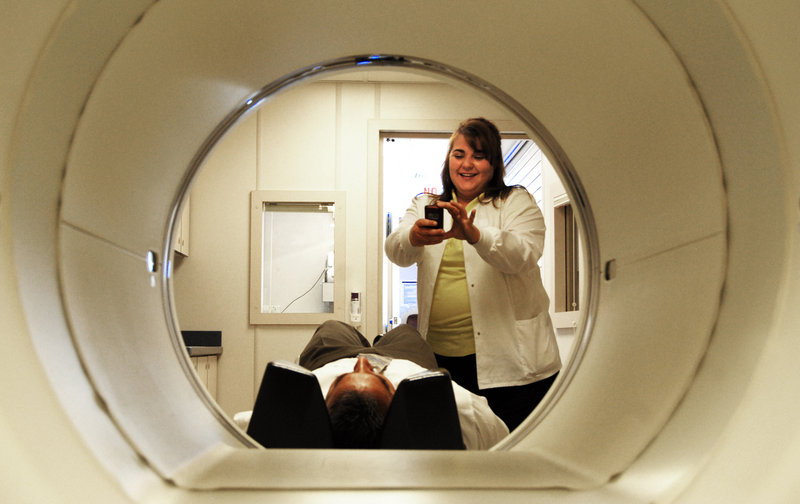 Erin Bialowas, standing, a positron emission tomography technologist, and Norm Amann demonstrate a PET scan at a Roswell, N.M., hospital. Columbia University’s Kreitchman PET Center has halted some research after officials complained that impure drugs were being used on patients during PET scans, which might affect patients’ health in unpredictable ways.