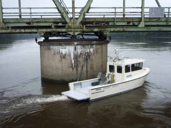 The underwater survey vessel Orion inspects one of the piers holding up the Kennebec River bridge in Richmond.