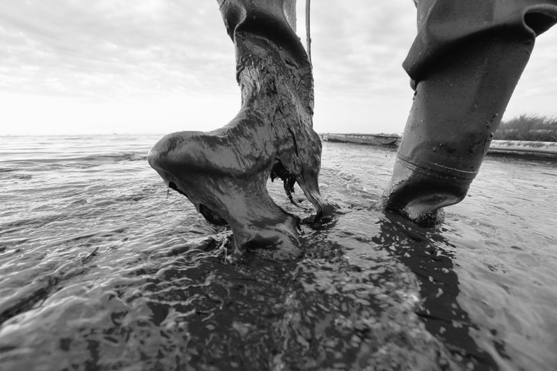 Boots not made for walking in thick beached oil are worn by Plaquemines Parish, La., coastal zone director P.J. Hahn at Queen Bess Island in Barataria Bay. After three long months, the bleeding from the bottom of the Gulf of Mexico has finally been stanched. But in many ways, the prognosis remains uncertain.