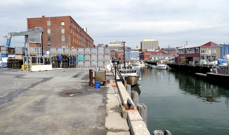 A waterfront lot that abuts the Cumberland Cold Storage building is used by fishermen on the Portland Fish Pier.