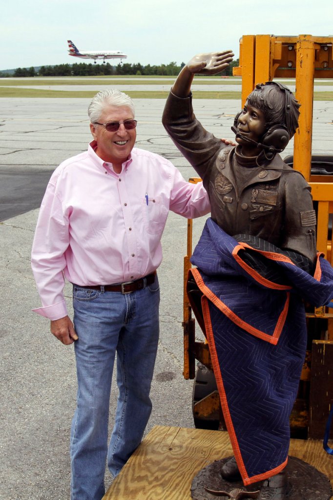 Jim Van Meter of St. George, Utah, poses Tuesday with a statue of his late daughter, Vicki, at the Augusta State Airport, where her record 1993 and 1994 flights began.