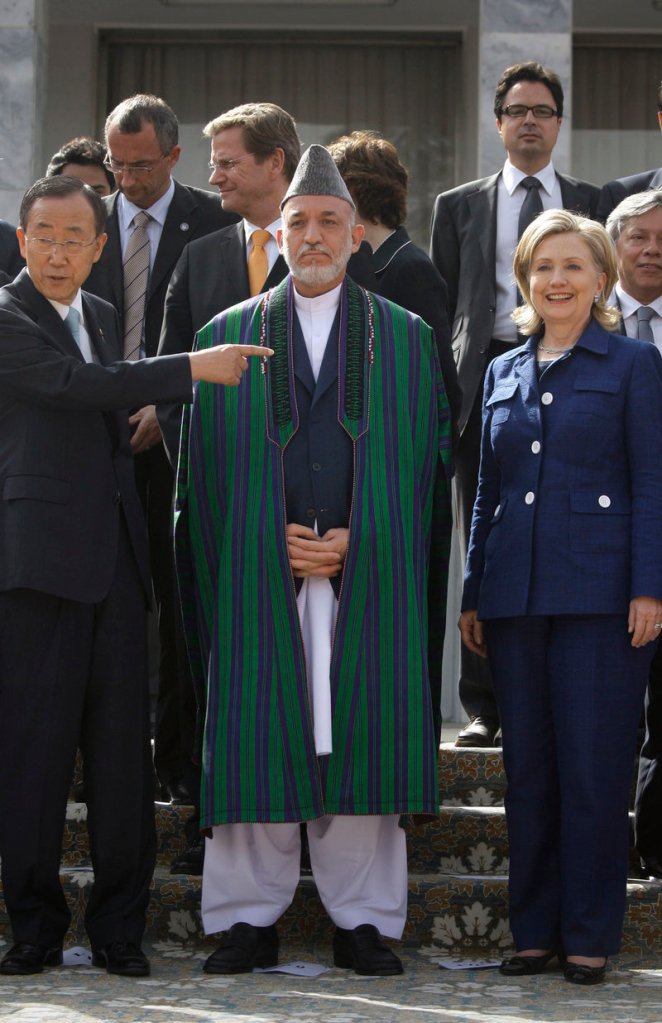 U.N. Secretary General Ban Ki-moon gestures as Afghan President Hamid Karzai and U.S. Secretary of State Hillary Rodham Clinton prepare to pose for a photo in Kabul on Tuesday.