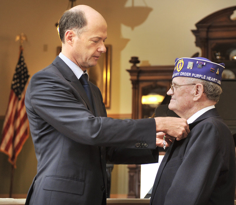 Elvert Pooler receives the Legion of Honor medal Wednesday from Christophe Guilhou, consul general of France in Boston, at the Sanford Springvale Historical Museum. "Pooler was ready to sacrifice himself for France," Guilhou said.