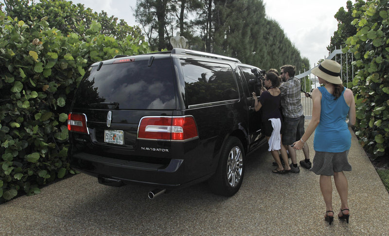 The media flock around the SUV carrying Conrad Black to his Palm Beach, Fla., home Wednesday.