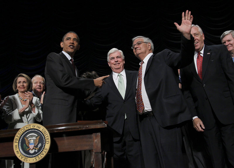 President Obama points to Sen. Chris Dodd, D-Conn., center, and Rep. Barney Frank, D-Mass., right, after signing the Dodd-Frank Wall Street Reform and Consumer Protection Act.