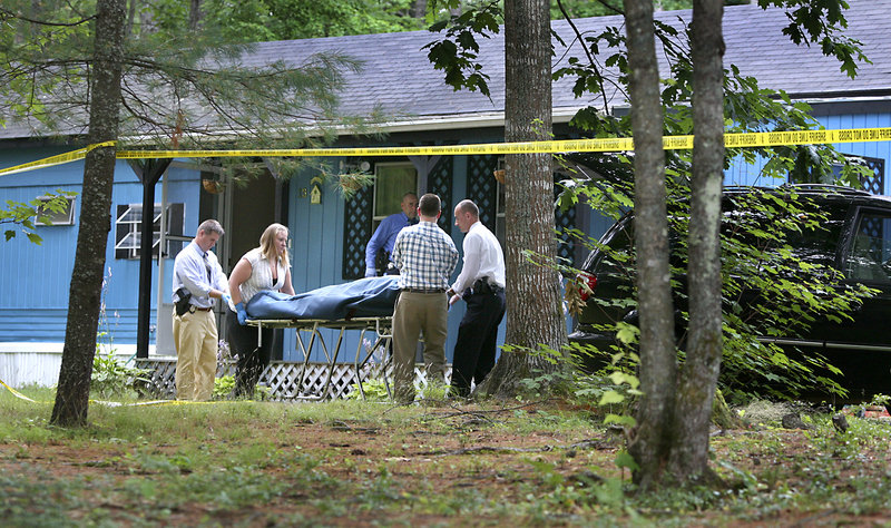 A body is removed from a mobile home Wednesday on Brook Drive in Hollis. Police believe that Mike Lagarde shot his wife, Freda, then shot himself in a murder-suicide. Their adult daughter found the bodies.