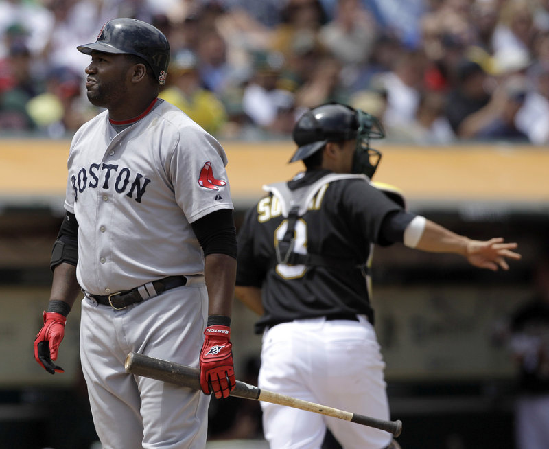 David Ortiz of the Boston Red Sox reacts Wednesday after striking out to end the top of the fifth inning with a runner on second. The Oakland catcher is Kurt Suzuki. The Red Sox are 2-5 since the All-Star break and seven games behind the New York Yankees.