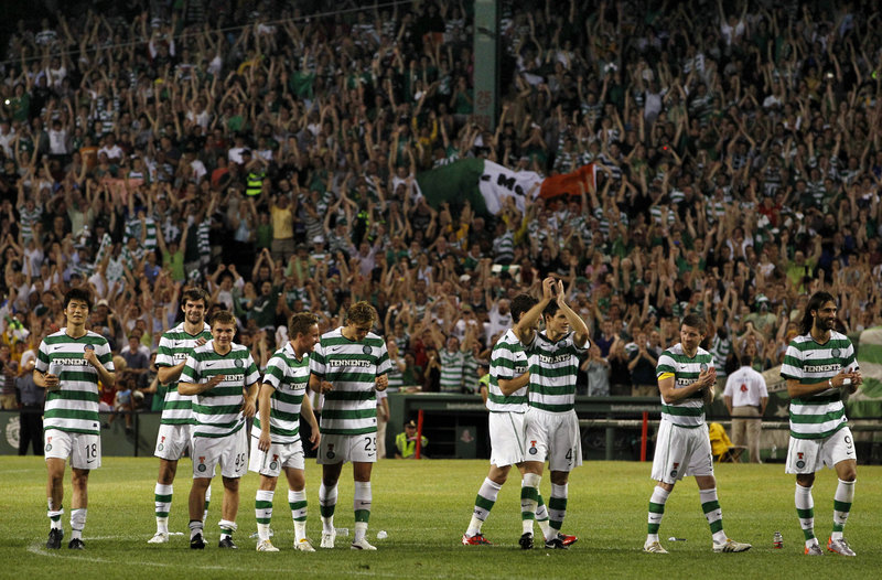 With the game over, members of the Celtic soccer team of Scotland applaud the Fenway Park crowd Wednesday night after beating Sporting Lisbon on penalty kicks.
