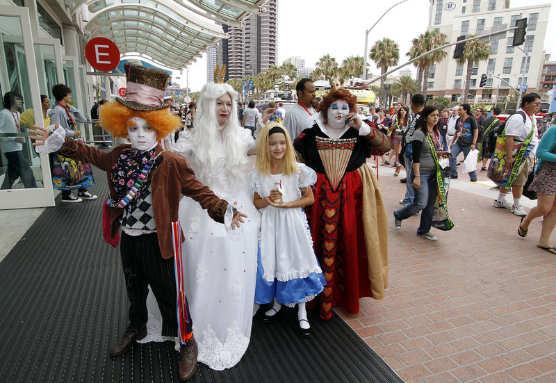 A family dressed as characters from “Alice in Wonderland” pose for a photo outside of the Comic-Con International Thursday in San Diego.
