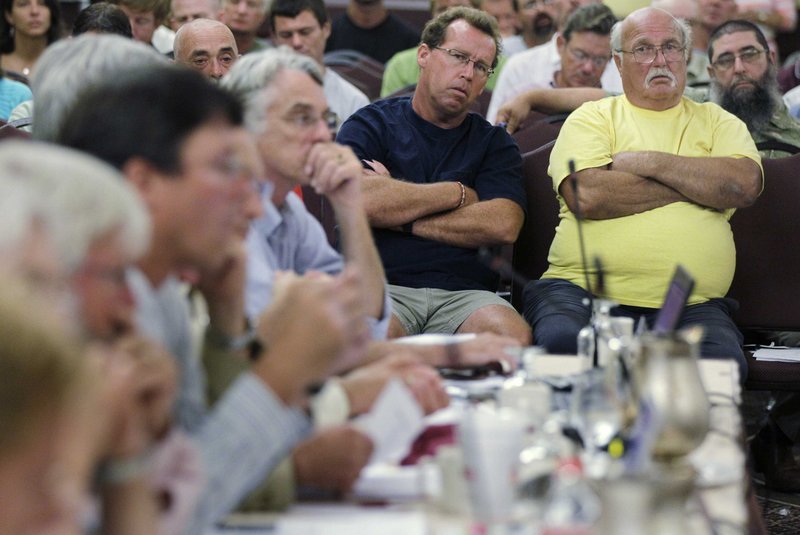 Lobstermen Joe Horvath of Belmont, N.J., right, and Tom Viesiadecki of Point Pleasant, N.J., listen during a meeting of the American Lobster Management Board in Warwick, R.I., on Thursday.