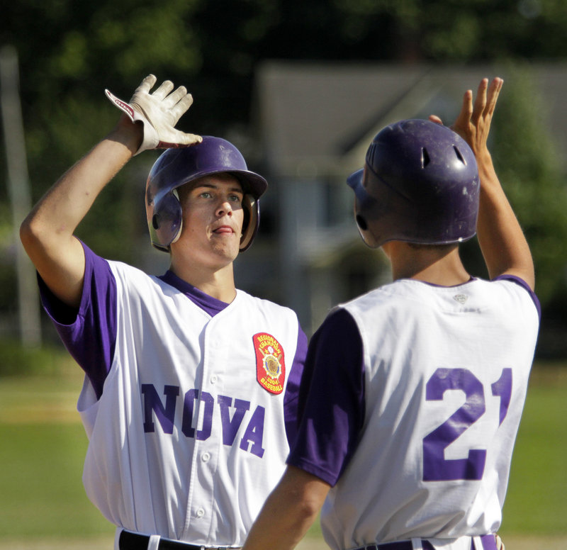 Kyle Danielson of Nova Seafood, left, is welcomed by Sam Balzano after scoring. Nova Seafood will be seeking its third straight American Legion state title.