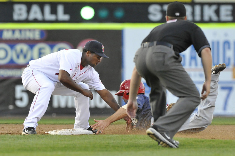 Yamaico Navarro of the Portland Sea Dogs slaps a tag on Danny Espinosa of the Harrisburg Senators, who was caught trying to steal second in the third inning Thursday night.
