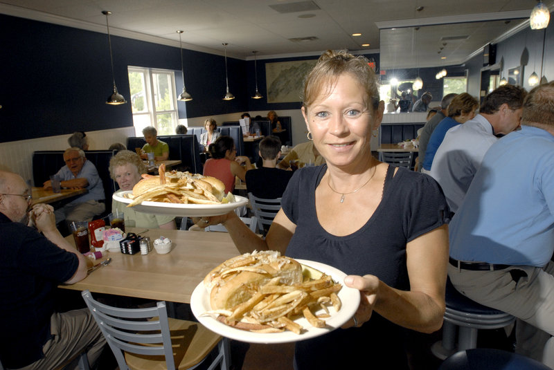 Server Judy Dyer hoists a couple of Burn Dog plates (hot dog with sauerkraut and side of fries).