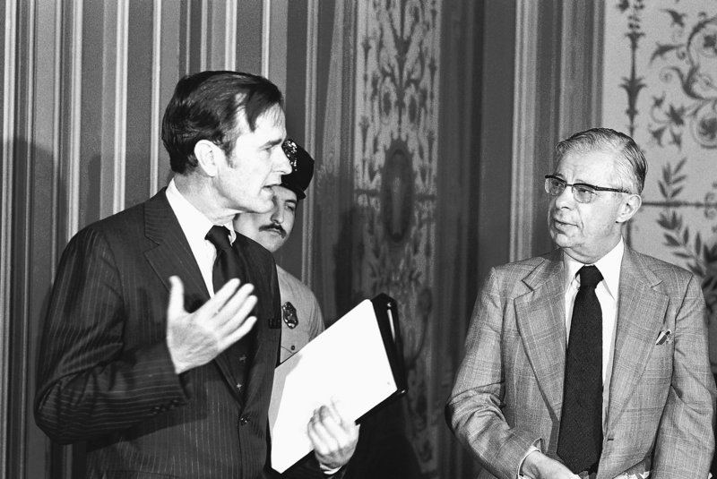 CIA Director George Bush, left, exchanges words with CBS newsman Daniel Schorr in 1976 before Bush’s closed-door briefing to members of the Senate Foreign Relations Committee.