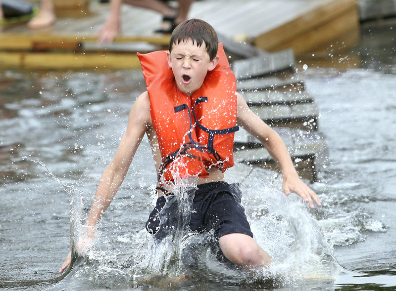 Nate Vintinner, 13, of Richmond jumps into the water during the lobster crate races.