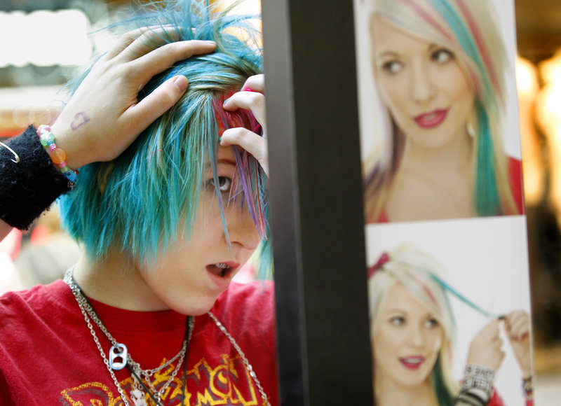 Amelia Midgley, 14, of Boston colors her hair at a booth operated by Hot Topic, a teen retail store at the Maine Mall in South Portland, on Saturday.