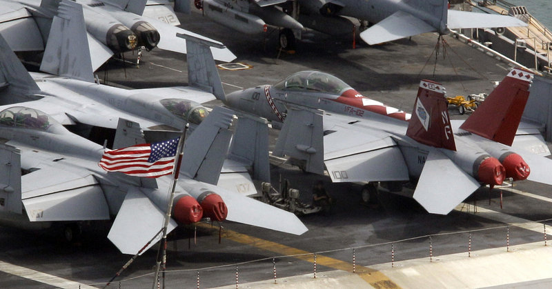 Fighter jets await action aboard the USS George Washington in Busan, South Korea. North Korea warned Saturday that joint U.S. and South Korean military exercises this weekend amount to a military provocation that will draw a "powerful" nuclear response from Pyongyang.