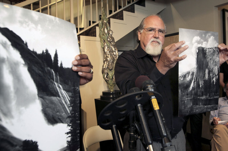 Rick Norsigian holds up a photograph made from an Ansel Adams glass negative at a news conference Tuesday in Beverly Hills, Calif. Norsigian bought 65 negatives at a garage sale a decade ago that experts have since authenticated as Adams’ work.