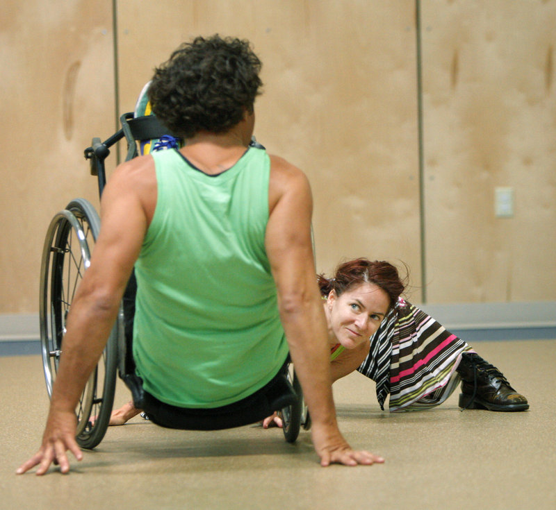Giles, right, looks to Bell as they perform. They are with Axis Dance Company, which includes dancers with and without disabilities.