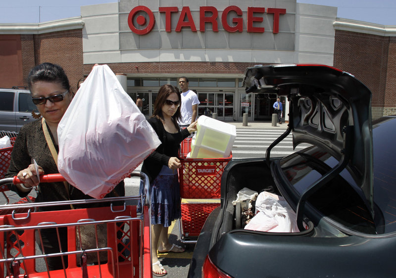 Joselin Pena, left, and her niece Ingrid Romero put their purchases in their car at a Target in Boston. A political donation by Target to a candidate who opposes gay marriage has led to talk of boycotts and a Facebook drive against corporate donations.