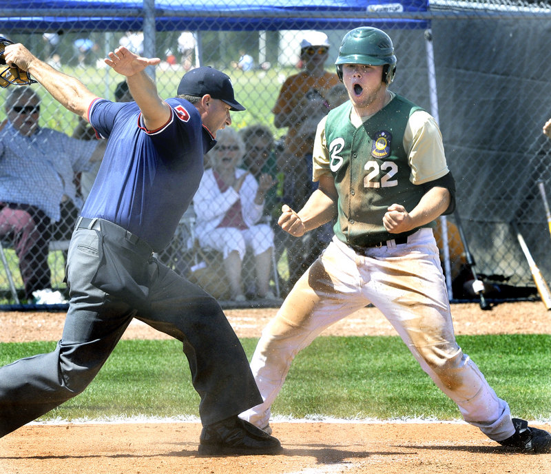 Matt Verrier of Bessey Motors celebrates Wednesday as the plate umpire signals Verrier was safe at home. He scored on a sacrifice fly to open the scoring in the fifth inning, but Nova Seafood came back to win the American Legion state tournament opener, 7-4.
