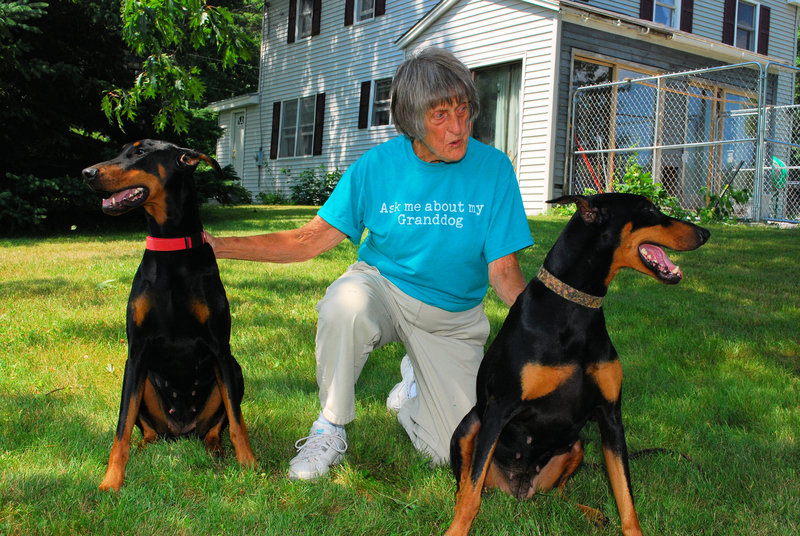 Evelyn Stackpole with her dogs Glory and Paige, two of the many Doberman pinschers she raised and trained.