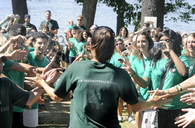 American soccer star Mia Hamm is greeted by campers during her visit to the Seeds of Peace Camp in Otisfield.