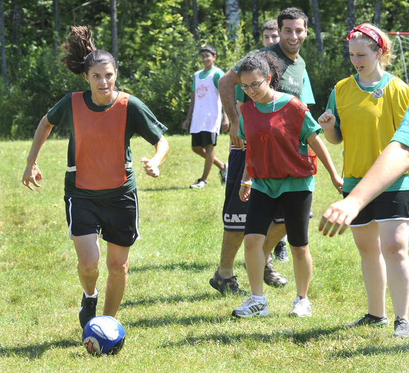 Mia Hamm, left, gives a soccer clinic to campers Thursday during a visit to the Seeds of Peace Camp in Otisfield. “This is ... beyond my expectations,” she said. “It’s emotional.”