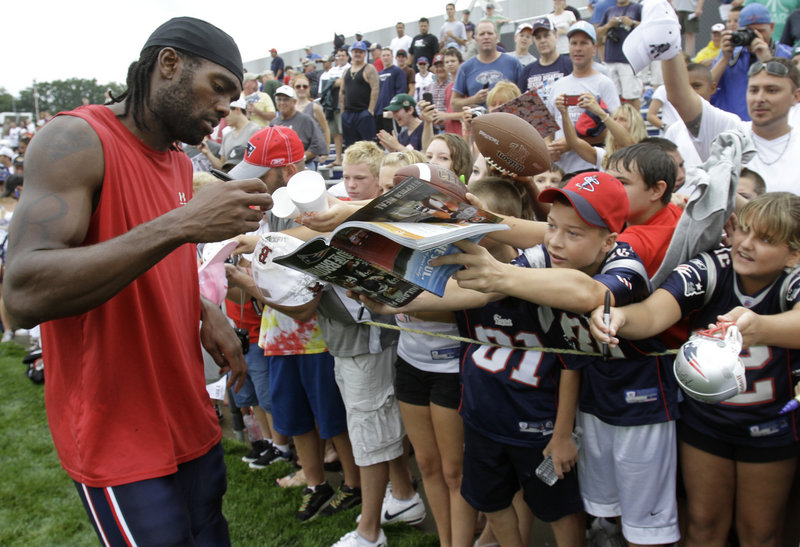 Randy Moss, signing autographs Thursday during the first day of training camp for the New England Patriots, will be one of the players needed to return the team to the top.
