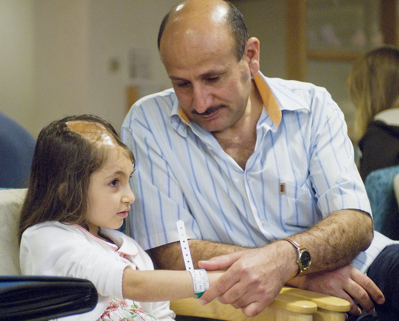 Six-year-old Noora Afif Abdulhameed is shown with her father, Afif Adulhameed Otaiwi, as she prepares for a CT scan to assess the extent of her head injury in July 2008 at Maine Medical Center in Portland.