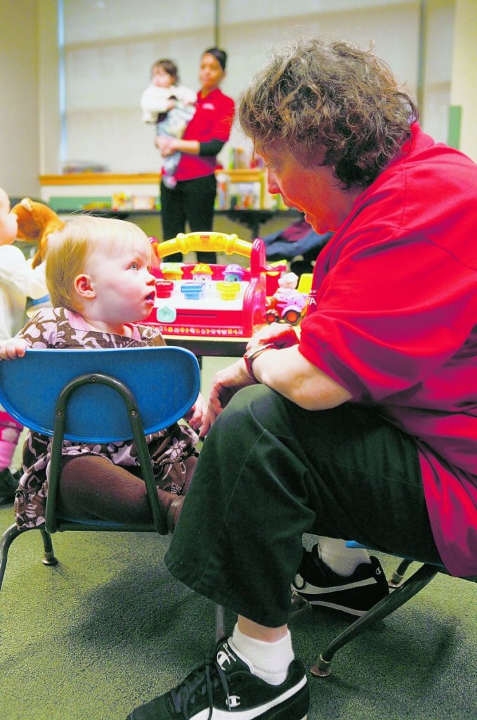 YMCA child sitter Rosalind Romero plays with Reef Hall, 16 months old, at the McBurney YMCA drop-in day care center in New York. A new study by Columbia University researchers finds that babies raised by working mothers don’t necessarily suffer cognitive setbacks.