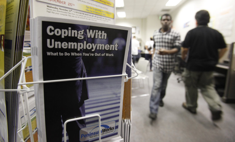 People seek employment opportunities at an employment office in Menlo Park, Calif. The recovery lost momentum in the second quarter as growth slowed to a 2.4 percent pace, its most sluggish showing in nearly a year.