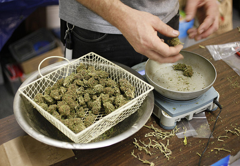 In Maine, dispensaries are planning to price their pot at $300 to $400 an ounce, which is reportedly what the drug costs on the street. In this photo, a worker at a San Francisco marijuana clinic prepares packets of marijuana buds for sale.