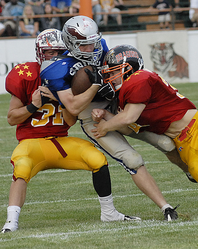 Mike Foley of South Portland runs out of room while hit by Frankie True of Mt. Ararat, right, and Brandon Levasseur of Orono. The annual Lobster Bowl has raised more than $370,000 in 21 years for Shriners hospitals for children.